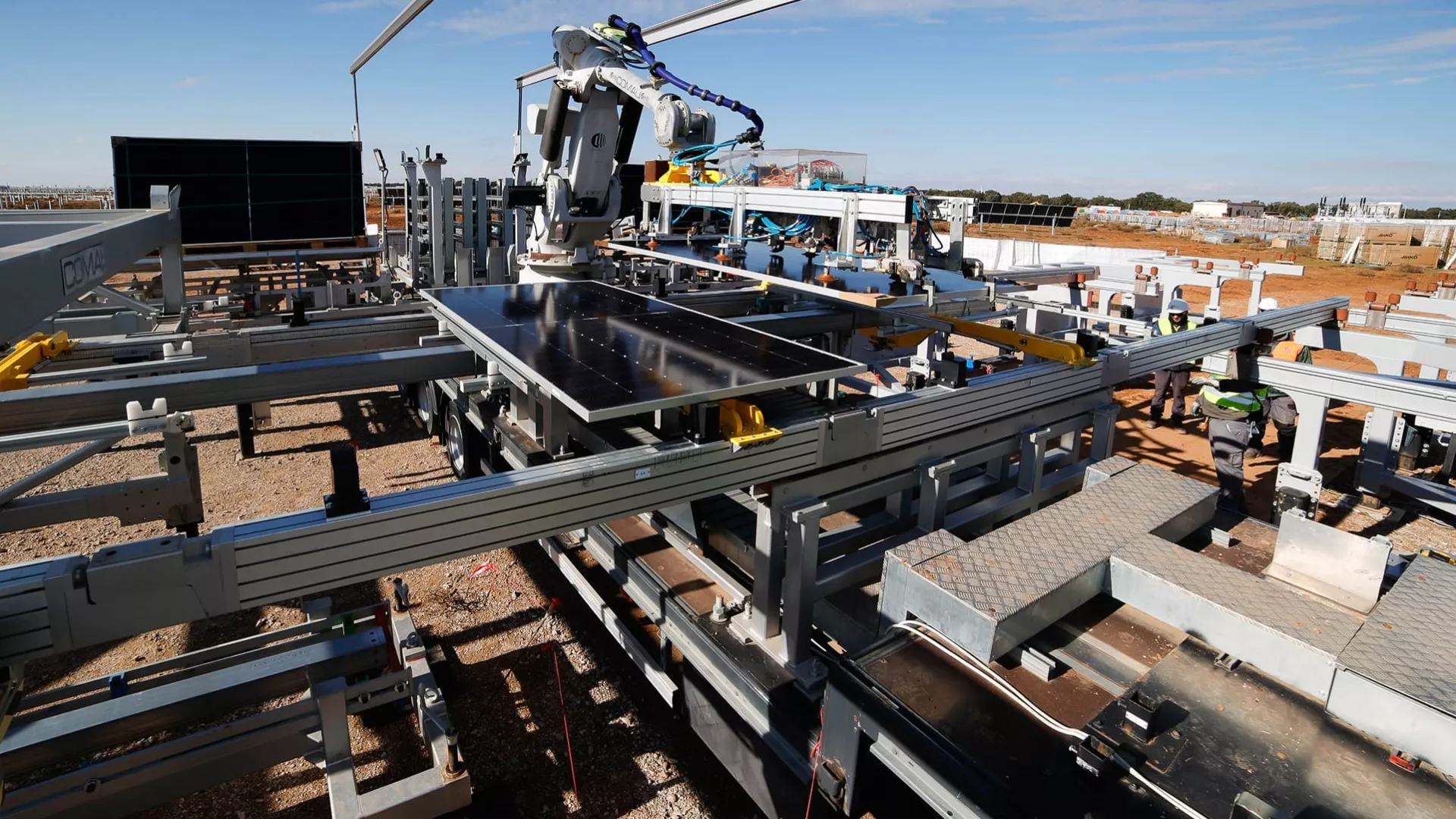 industrial solar panel assembly line featuring a robotic arm handling solar panels, with workers overseeing the automated manufacturing process